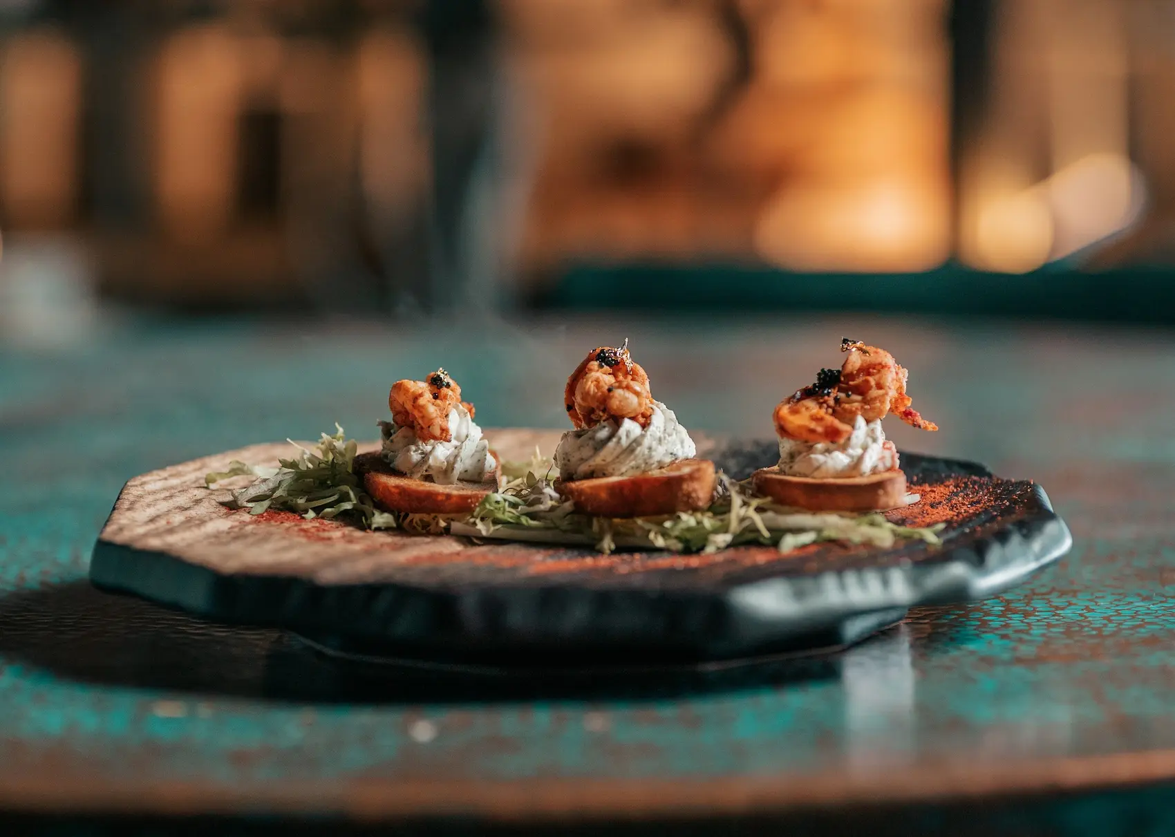 Gourmet shrimp canapés with herbed cream cheese and caviar garnishes, served as elegant appetizers for an elevated bridal shower catered by Gather Catering.